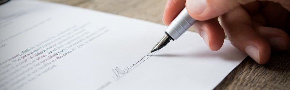 hand signing a letter